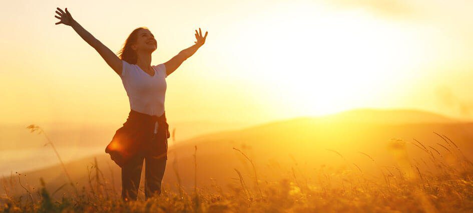 lady stretching outside with her arms up