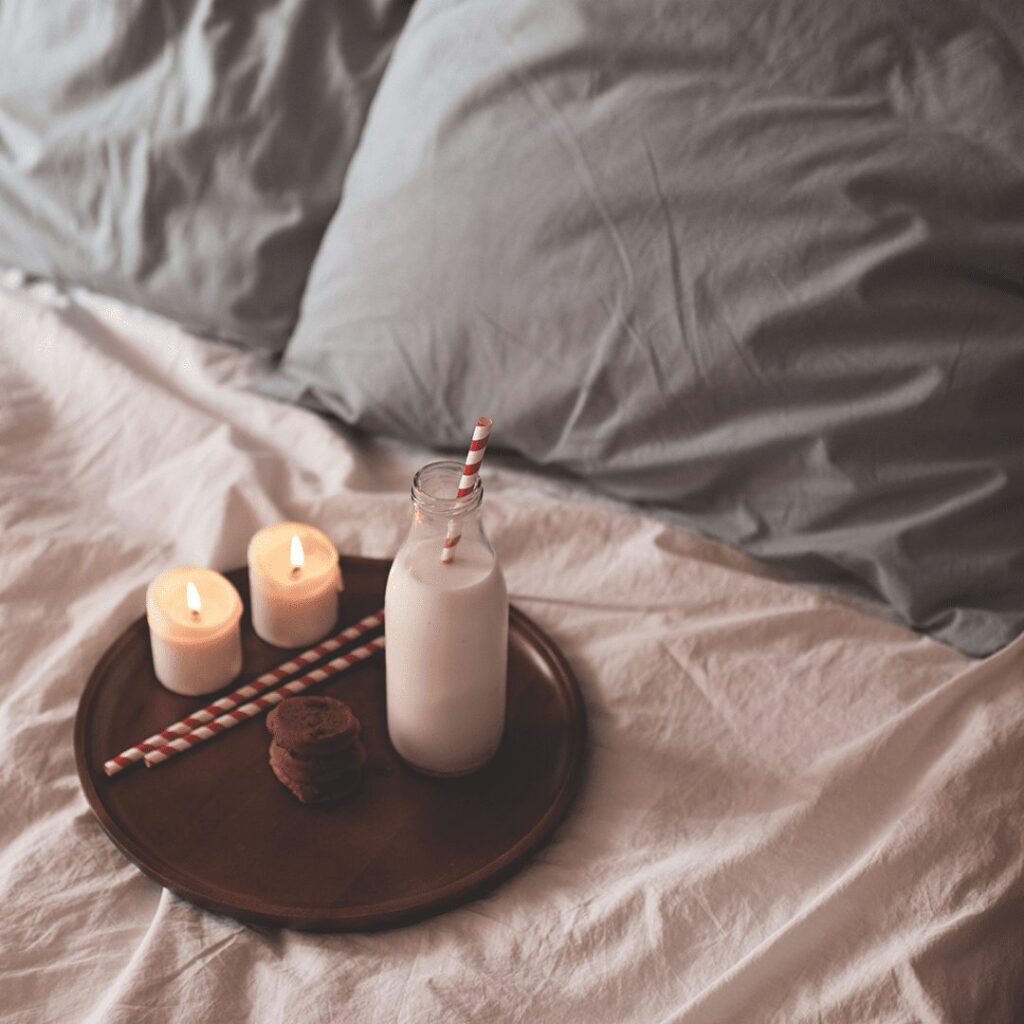 milk and cookies on a trap with a candle
